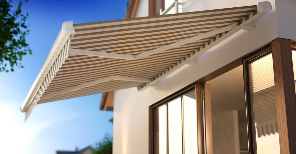 Ausgefahrene Markise über Terrasse, gestreift in Beige und Olivgrün, blauer Himmel, Sonnenschein