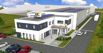 Ein modernes zweistöckiges Bürogebäude mit dem Schriftzug AUSTROTHERM auf einem Schild und Fahnen steht neben einem großen Lagerhaus. Im Vordergrund sind Parkplätze und Menschen zu sehen.