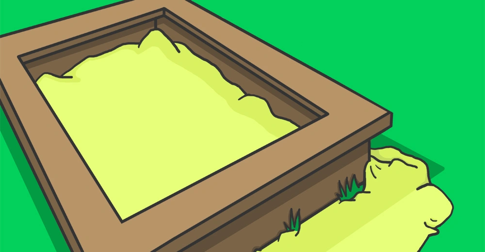 Holzrahmen mit gelbem Sand darin Gras wächst um den Rahmen auf grünem Hintergrund