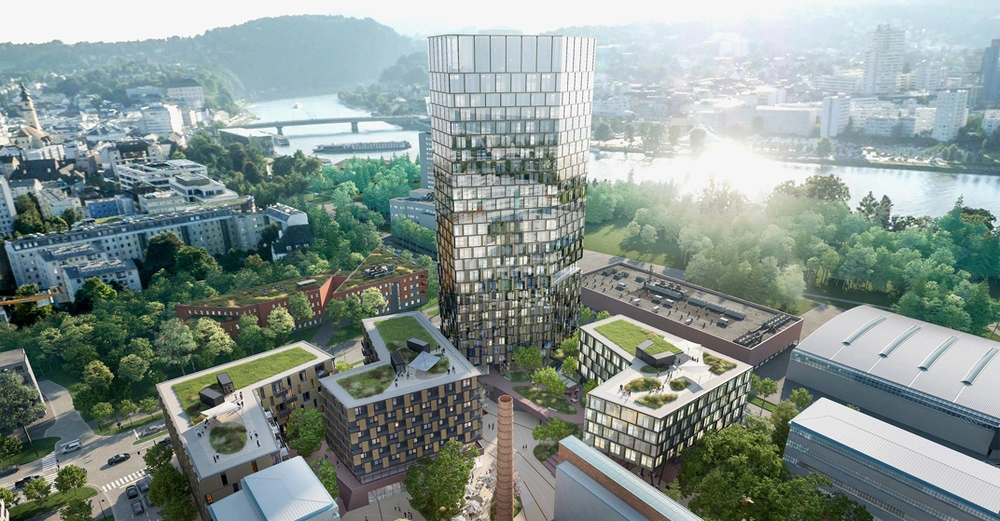 Hochhaus reflektiert Sonnenlicht Stadt mit Fluss im Hintergrund kleinere Gebäude und Grünanlagen umgebend helle Landschaft Stadtentwicklung baumbestandene Uferpromenade steinerne Brücke im Wasserufer.