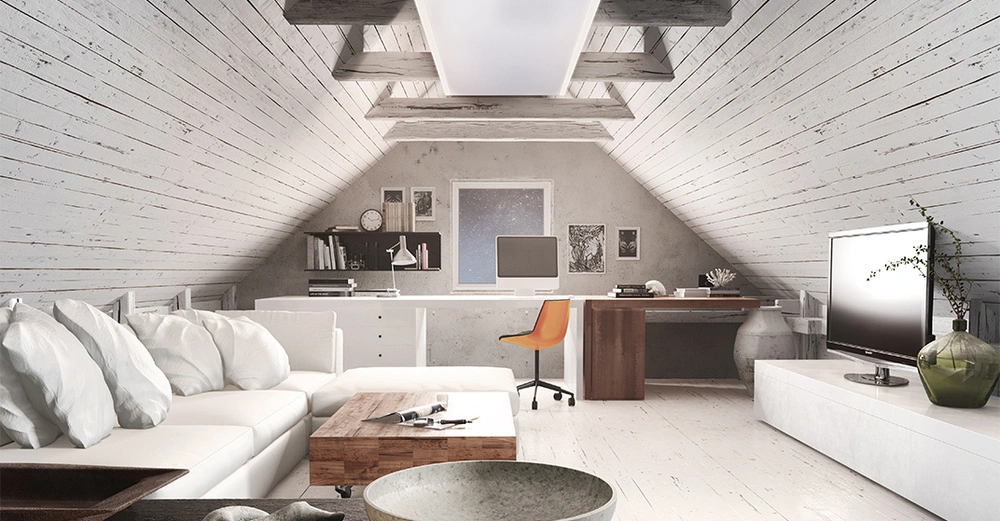 Weißes Sofa mit Kissen steht neben einem Couchtisch in einem gemütlichen weißen Dachzimmer mit Schreibtisch Stuhl Computer Bücherregalen und Fernseher.