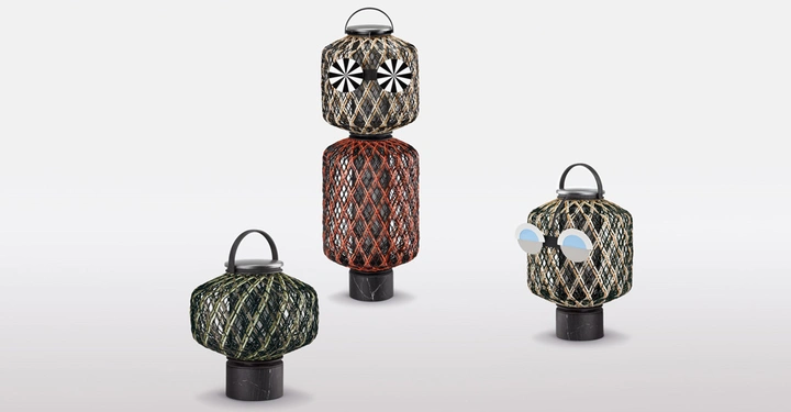 Drei Laternen mit Netzen umwickelt stehen auf einem weißen Hintergrund. Zwei Laternen haben dekorative Augen, die linke sieht aus wie eine Eule die rechte mit Sonnenbrille.