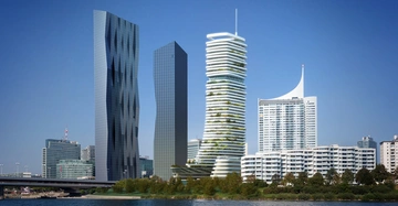 Hochhäuser stehen nebeneinander mit modernen Designs und Blickrichtung auf einen Fluss dahinter befindet sich eine Stadtlandschaft mit weiteren hohen Gebäuden und Bäumen am Ufer.