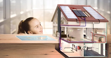 Kind lächelt Hausmodell Solaranlage zeigt Rohrleitungen im Hintergrund unscharfe Fensterumgebung