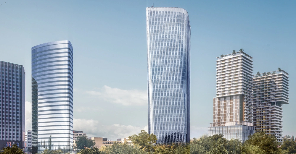 Mehrere moderne Hochhäuser stehen in einer städtischen Umgebung Bei Tageslicht ragt ein gläserner Turm in der Mitte hoch auf In der Nähe sind weitere stilvolle Gebäude, umgeben von Grünflächen