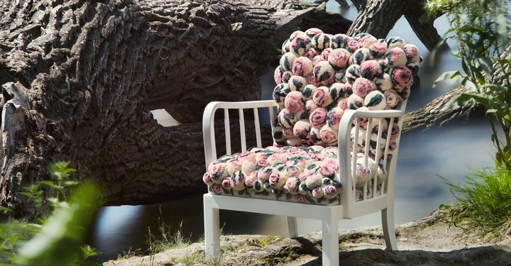 Galerie-Bild 4: Stuhl sitzt still auf moosigem Boden vor einem umgestürzten Baum am Ufer eines ruhigen Sees umgeben von üppigem Grün.