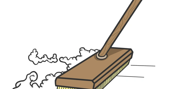 Ein Besen fegt Staub in einer Bewegung durch eine saubere Umgebung auf.