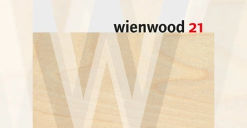 Holzplatte mit überlagertem großen Buchstaben W im Hintergrund wienwood 21 oben rechts in schwarzer und roter Schrift vor grauem und holzfarbenem Hintergrund.