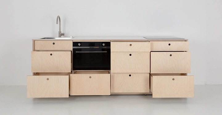 Modulküche Eva in Frontalansicht, helles Holz, geöffnete Schränke und Laden, in der MItte der Elektroherd.