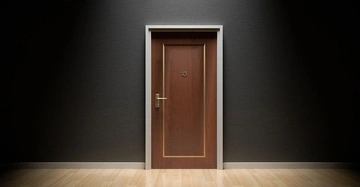 Holztür mit der Nummer 13 geschlossen in einem Raum mit dunklen Wänden und einem hellen Holzboden.