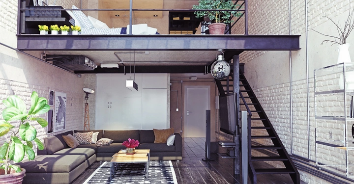 Gemütliches Wohnzimmer mit grauem Sofa und Kissen vor weiß gestrichener Ziegelmauer modernes Loft mit Zwischengeschoss und Treppe Pflanzen und Disco-Kugel dekorieren den Raum Holzboden und Teppich ergänzen das Ambiente