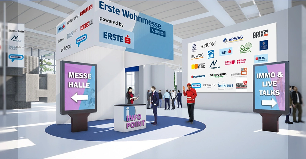 Infopoint mit einer Person die Informationen gibt in einer Messehalle mit leuchtenden Schildern Messe Halle und Immo & Live Talks im Hintergrund Menschen die sich unterhalten. Beschriftung Erste Wohnmesse powered by Erste