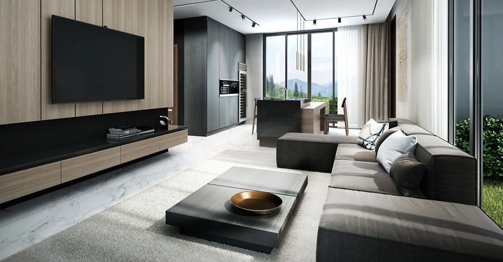 Graues Sofa und Couchtisch in modernem Wohnzimmer mit großem Fernseher an Holzwand Küche und Essbereich im Hintergrund große Fenster bieten Blick auf Garten und Berge.