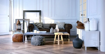 wunderschöner Stuck an weißer Wohnungswand in typischem Altbau, dazu dunkelbrauner Fischgrätparkett