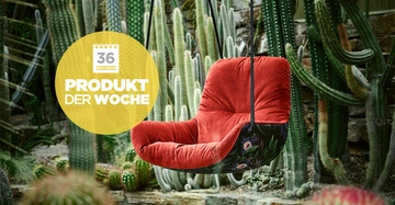 Ein roter Hängesessel schaukelt vor einer Kulisse aus Kakteen und Steinen. Text: 36 PRODUKT DER WOCHE.